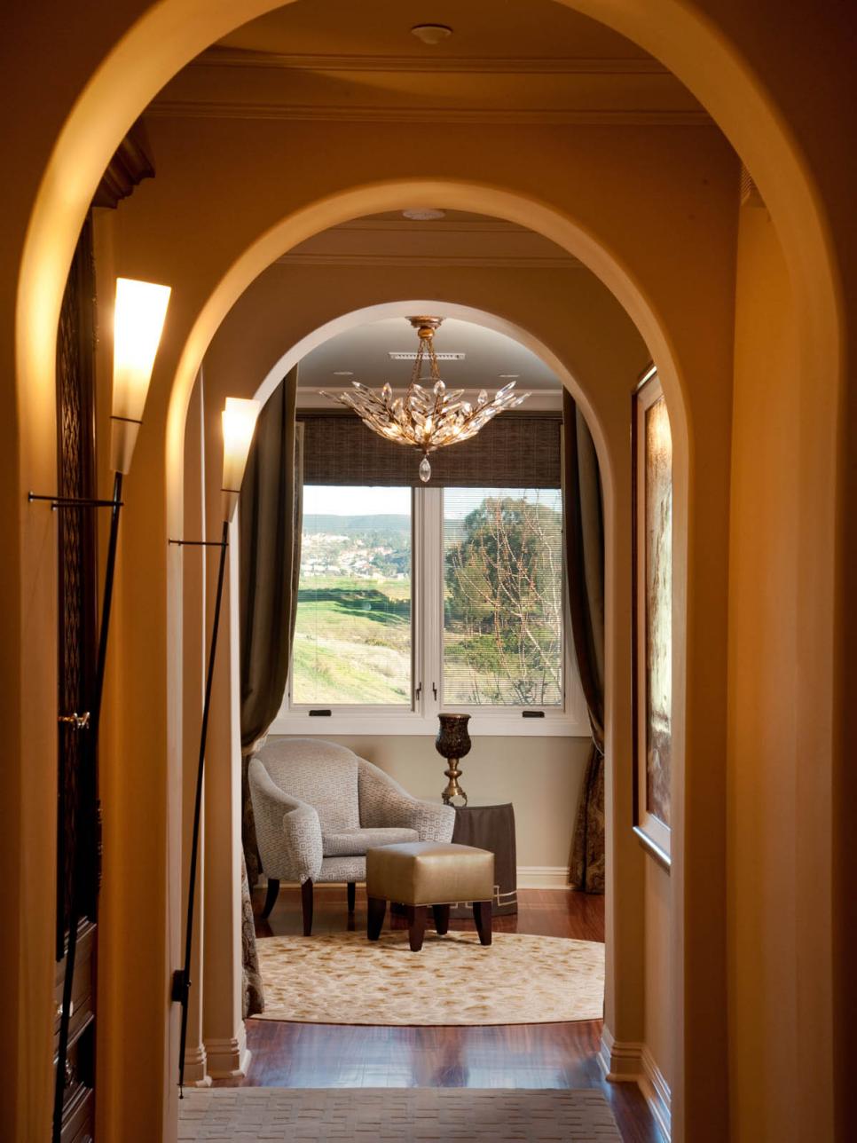 Master Bedroom Arched Entry Hallway With Sconce Lighting