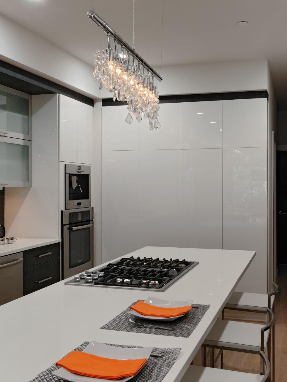 Modern White Kitchen with Crystal Chandelier and Large Island