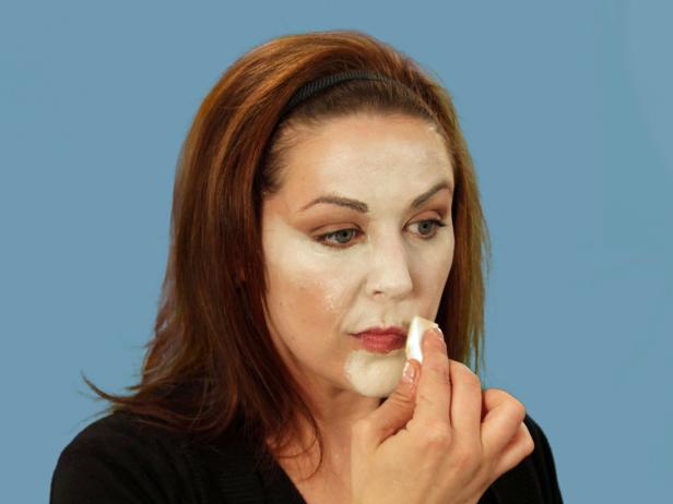 For enviable Halloween cat makeup, get the perfect base by using a makeup sponge to apply foundation that is several times lighter than your skin to the nose, middle of the forehead, under the eyes, along the cheeks and down the chin. Use a different makeup sponge and apply dark orange-brown foundation to all the areas not covered by the light foundation. Use a third sponge and lightly blend where the two colors meet. Use black eyeliner to fill in the brows. Add sharper angles over the middle of the eyes to create a dramatic peak. Heavily line the bottom lash line and extend the line out past the eye. Inside, extend the line a little down the inside of the nose. Line the top lash line and on the inside corner of the eye. Extend the top line to meet the bottom line. With the pencil, cover the eyelid, extending out beyond the eye. Blend the lines with a small, flat makeup brush to make them smooth.