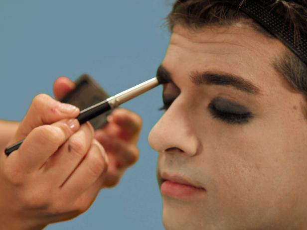 To intensify the dark, masculine nature, use the rounded brush and a little gray eye shadow to shade the inside of your eyes up to your eyebrows.