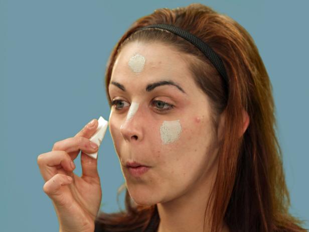 Start your zombie makeup with a base. With a makeup sponge, blend foundation over the entire face including the eyes, lips and neck area. Set the makeup using translucent powder.