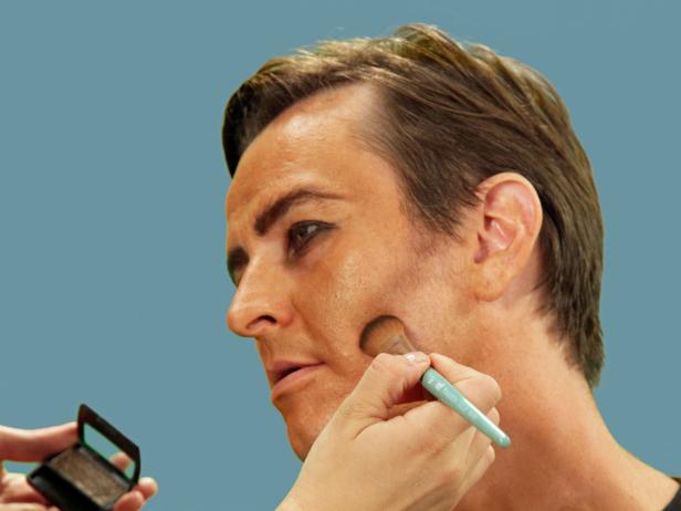 Using a craft brush and brown eye shadow, create contours under the cheek bones, blending down and out for a hollow look.