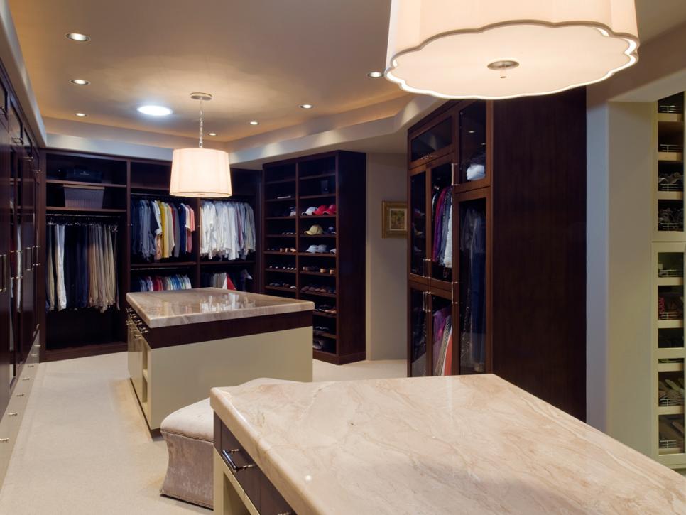 his-and-hers walk-in closet with shelves, cabinets and storage islands