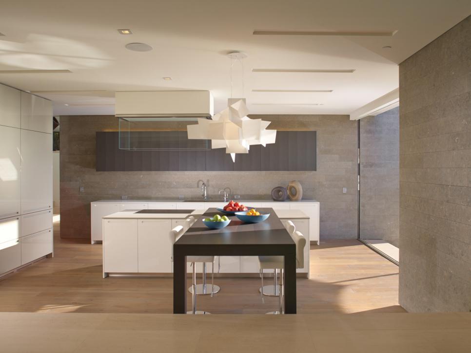 Modern neutral kitchen with artistic suspended light fixture