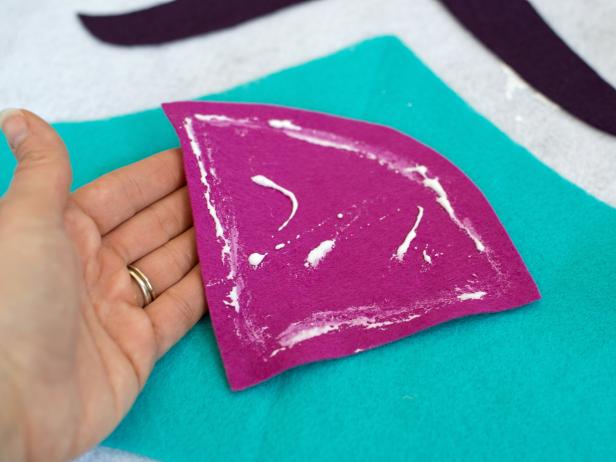 Once design for tree skirt is complete, glue felt pieces in place with fabric/felt glue.