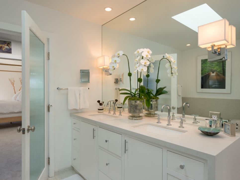 Sleek Contemporary Bathroom With White Cabinets and Sconce Lighting
