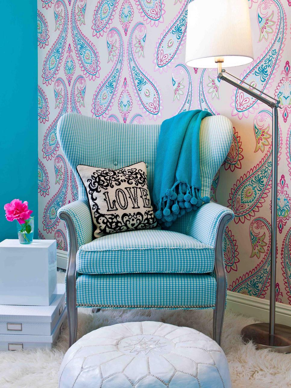 Blue and White Chair With White Pouf and Pink and Blue Wallpaper