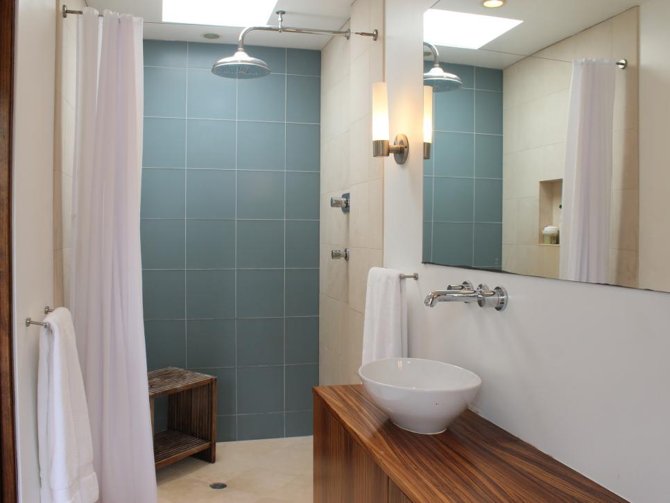Modern Bathroom With Blue Tiled Shower, Wood Vanity and Vessel Sink