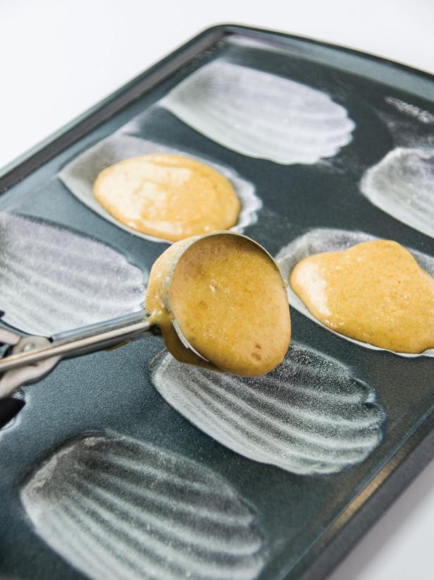 Use a leveled medium ice cream or cookie scoop to add batter to the madeleine pans