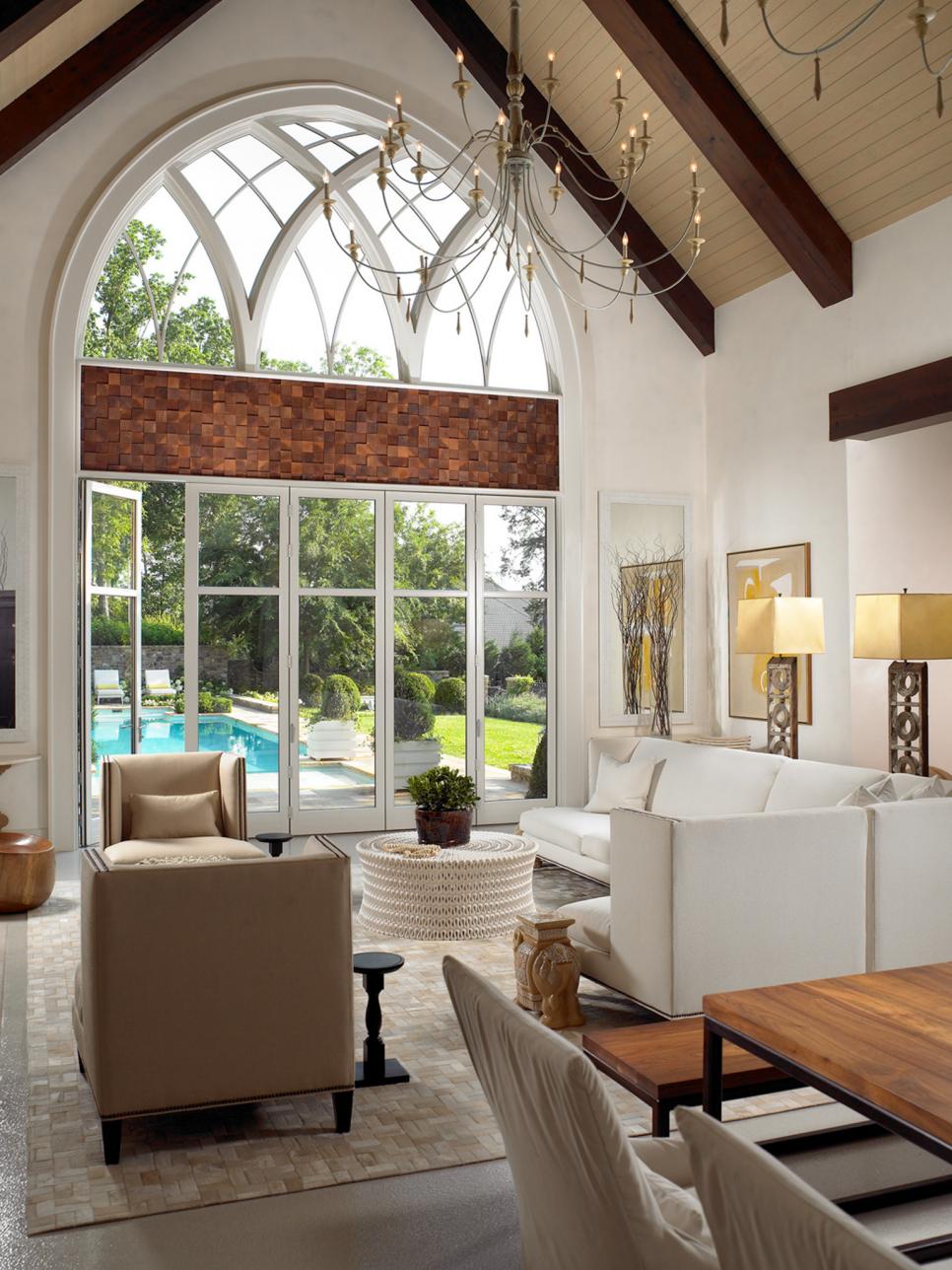 Great Room With Vaulted Ceiling & Thin Chandelier Overlooking Pool