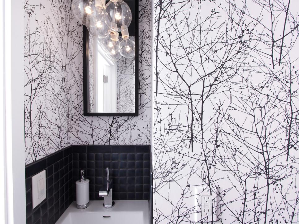 Half Bathroom With Tree-Patterned Wallpaper and Glass Globe Pendant
