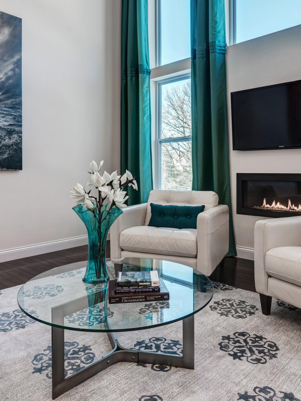 Contemporary Living Room With Turquoise Drapes and Wall Fireplace