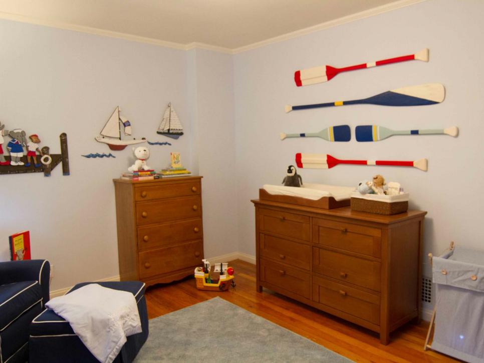 Pale Blue Nursery With Painted Oars Above Wood Changing Table