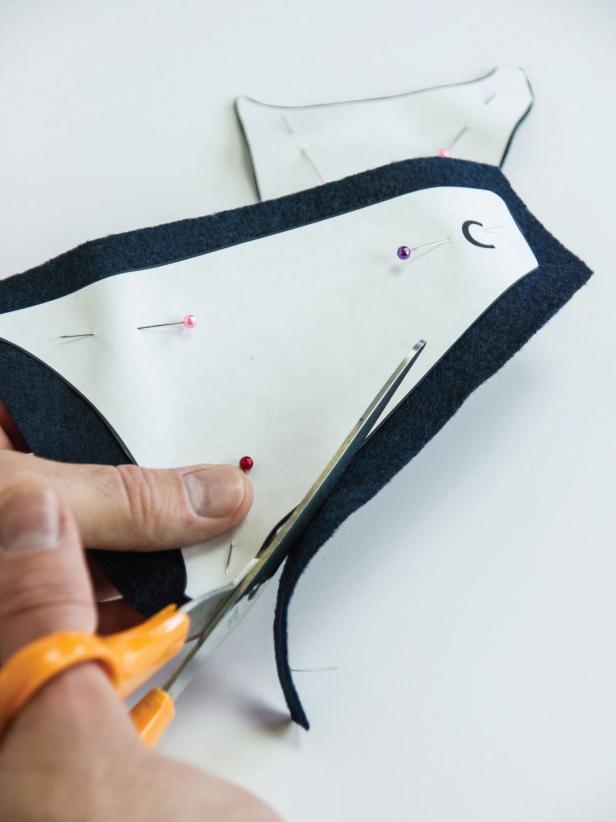 If you are using felt, the front and back of the fabric won’t matter. If using some other fabric, be sure to turn one of the templates over so you have pieces that mirror each other. Cut the pieces out and set aside.Lay the wing segment pieces out on the charcoal fabric. Flip as necessary for non-felt fabric. Cut the pieces out.