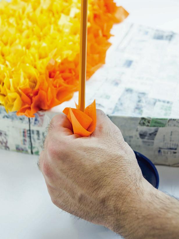 Fill in each section with the right candy corn color. To add tissue to the pinata make an ‘O’ with your forefinger and thumb. Lay a tissue square over the O and poke a pencil, erase end first, into the hole.