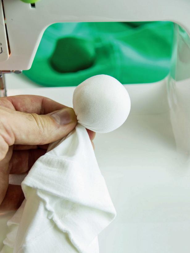 Stuff a small amount of fiber fill into the white kneww high. Gather the knee high together to form a tight ball.