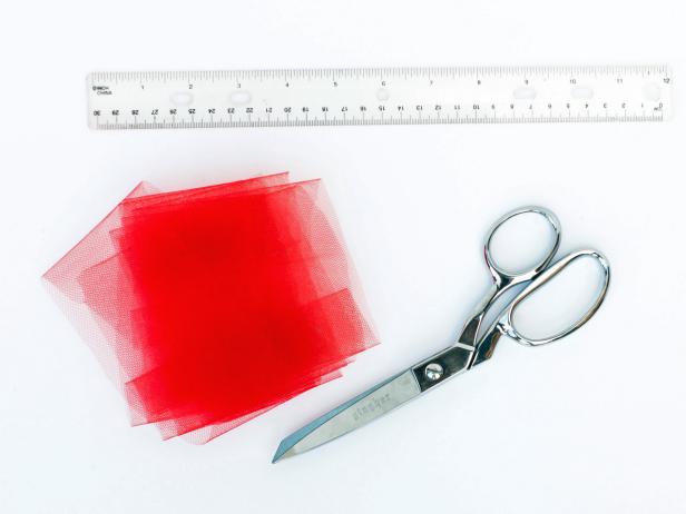 Measure the waist of the dog and cut the elastic 4" shorter, this allows the tutu to stretch and not fall off the dog. Hot glue the elastic ends together one end overlapping the other. After determining how long you would like the tutu, cut the tulle is 3" strips that are twice the length.