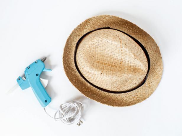 Secure around brim of that hat with hot glue.