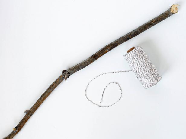 Find a stick with a slight curve to it. Cut a piece of twine to fit between the two ends to look like a bow for an arrow!