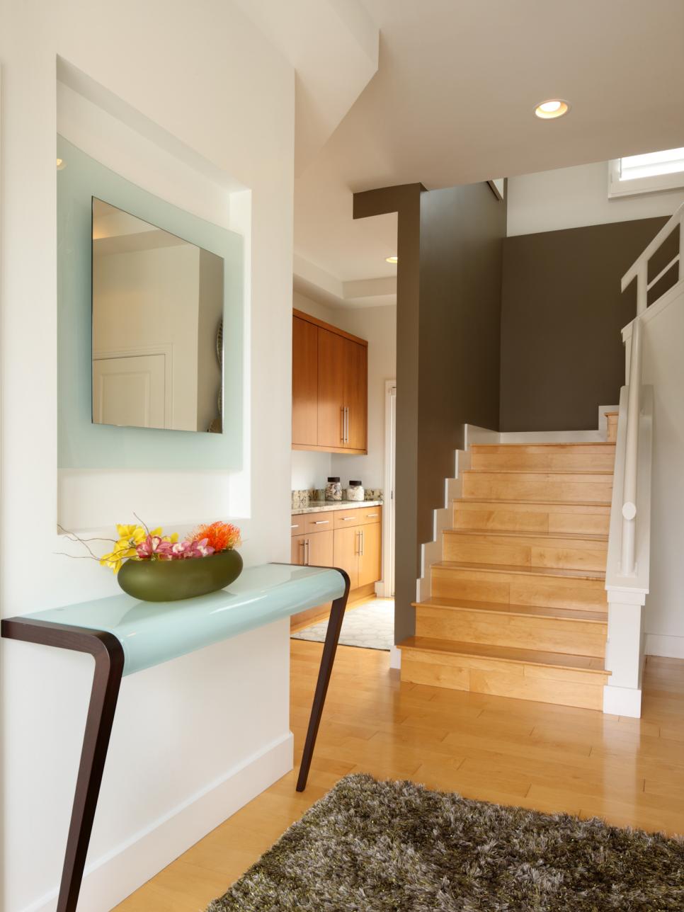 Entryway With Blonde Wood Floors, Blue Table and Frosted-Glass Mirror