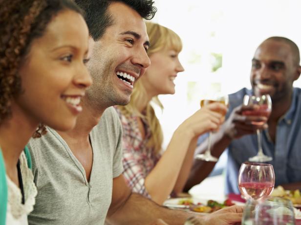 Group Of Friends Sitting Around Table Having Dinner Party