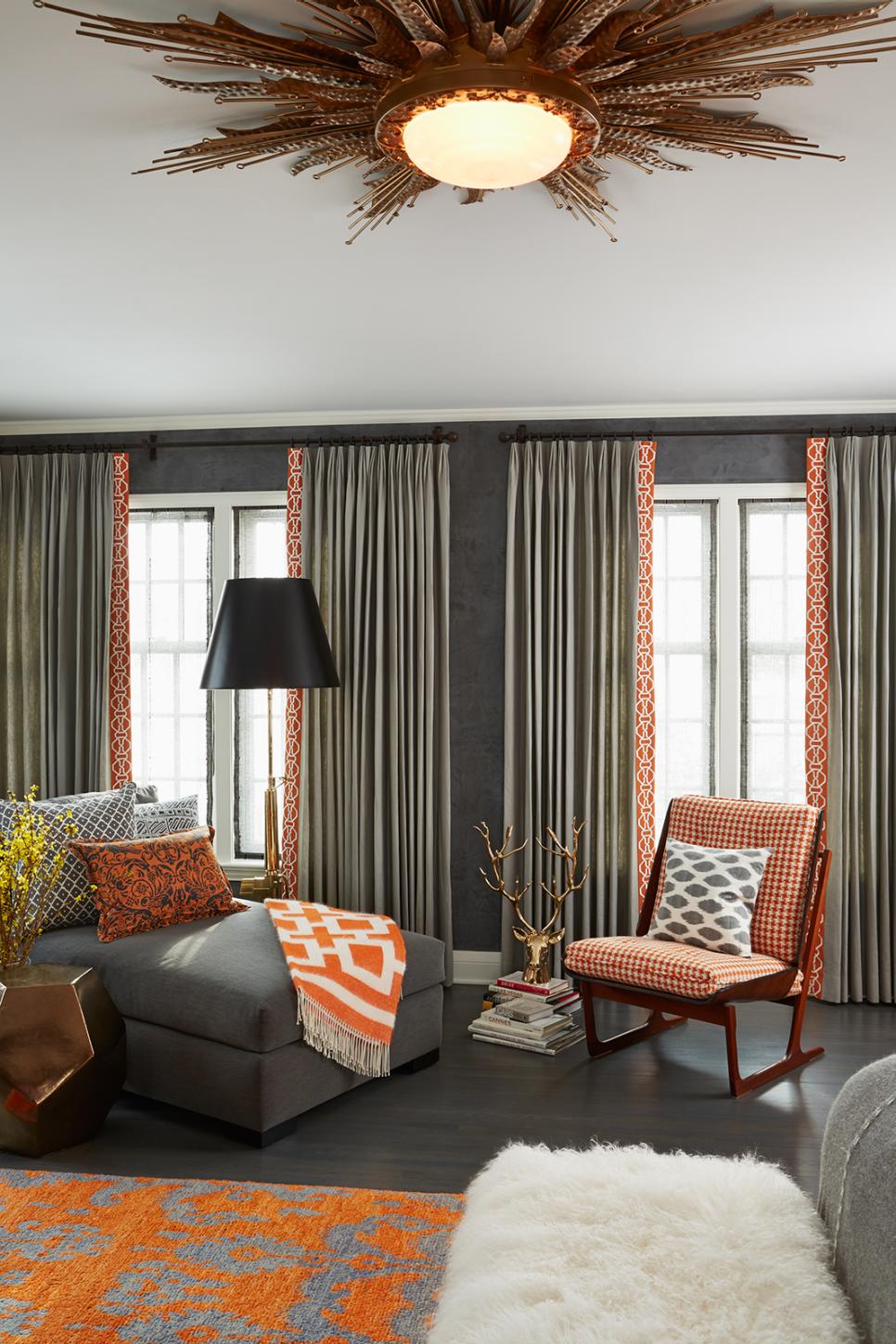 Eclectic Gray Bedroom With Fresh Orange Accents Dark Gray Bedroom With Gray Chaise and Orange Patterned Rug