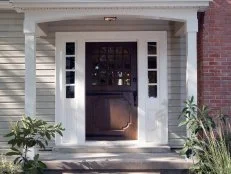 After of Exterior With Gray Siding, Dark Brown Door & Brick Walkway