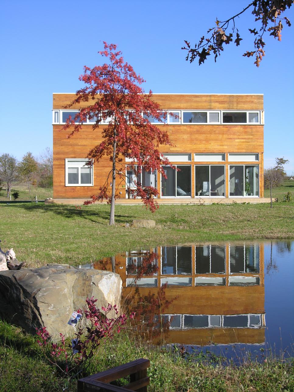 Contemporary Home Facade With Garden and Pond Red Tree and Exterior of Contemporary Home With Wood Siding