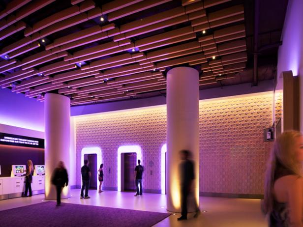 The lobby of the Yotel in NYC, lit by pink and purple lights.