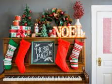 To add holiday charm to a sitting room, its piano was accessorized in place of a mantel. Pianos and organs offer a similar height as a mantel and also provide enough depth to layer different elements.