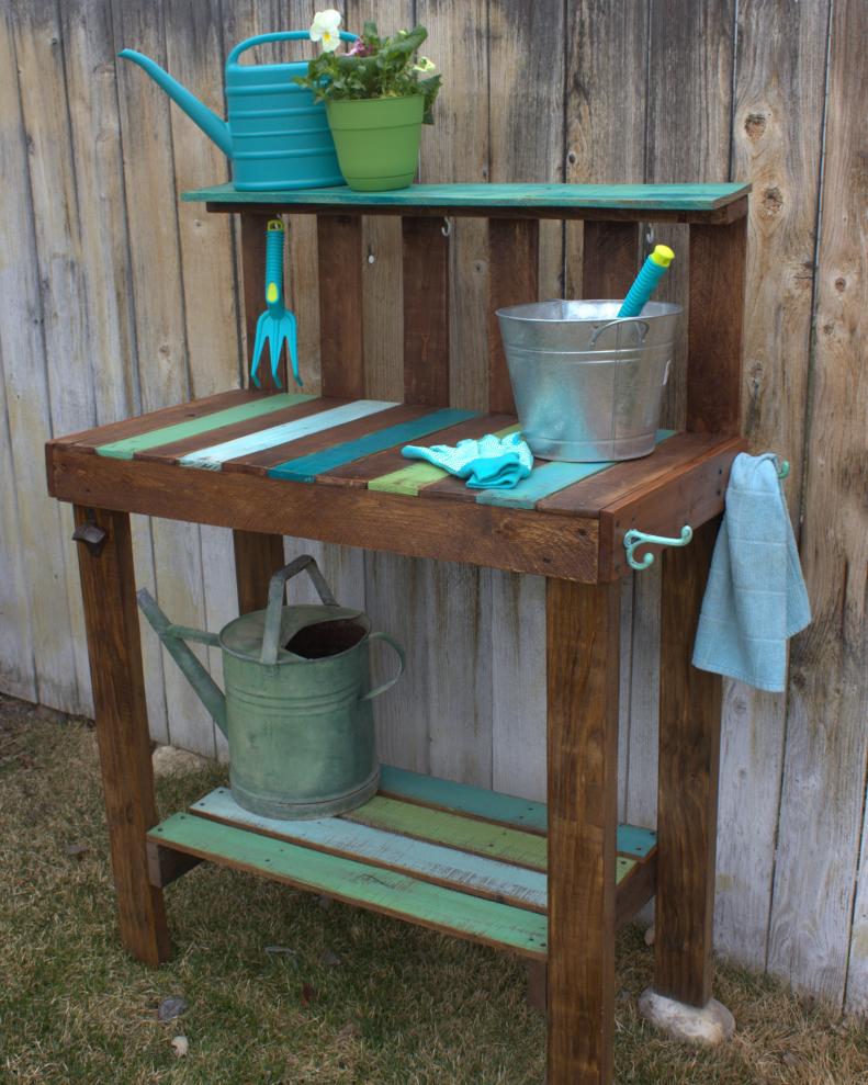Now you're ready to place the cut pallet boards into the spaces on the potting bench top. Use a brad nailer and 1-3⁄8" brads to secure them. "You could use 1-1⁄4" screws instead," Lamb says. "Accessorize your potting bench with hooks for garden tools, gloves, towels, and a bottle opener. Finish and protect the potting bench with a clear sealer made for outdoor use." Your bench can double as a gardening space or a buffet when you're entertaining. "(It) doesn’t have to go outdoors if you have more use for it indoors—it looks great in a kitchen or entryway.”
