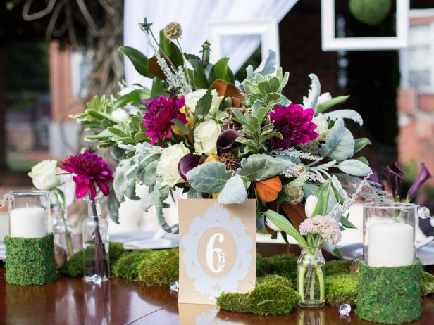 To keep a wedding design cohesive, Kim Lettier, of Lettier Event Planning Studio, carries some elements of the focal point (here, it's a floral centerpiece) into other areas. "Accent pieces such as candles should complement the focal point but not compete with it," she adds. “The design of the vessel itself should also fit in with the overall look. In this case I wrapped moss around the vessels because its traditional look interfered with the organic and vintage feel of the design.” Florist: The Green Flamingo.