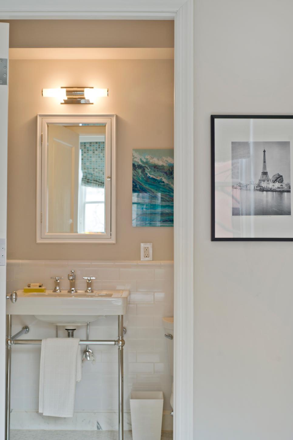 Clean, Classic Bathroom Features White Subway Tile Transitional Neutral Bathroom With White Tile and Blue Ocean Artwork