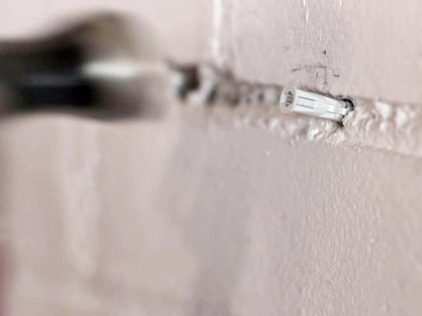 Use a drill to insert the anchors into your wall to support your shelves.