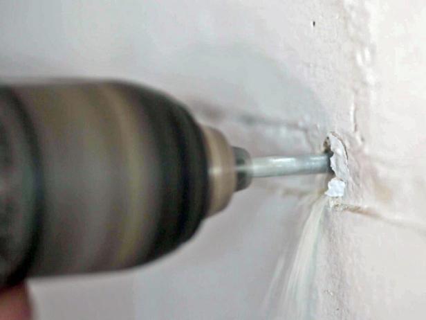 Drill holes in wall to make a place for your anchors.