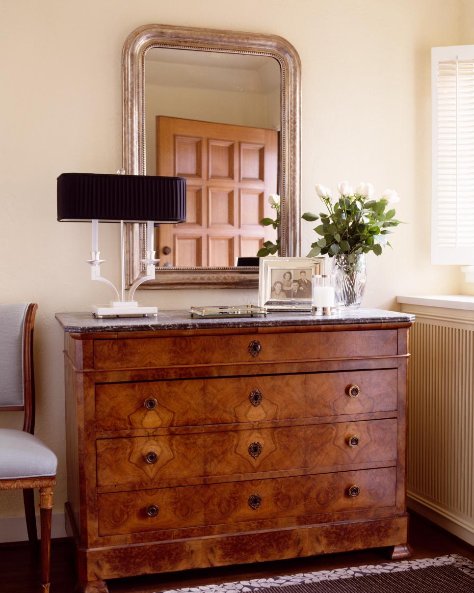 Traditional Foyer With Wood Chest and Antique Mirror Traditional Neutral Entry With Brown Chest and Framed Mirror