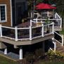 Stairs can do more than enable movement on and off a deck. The flared design of these stairs adds visual interest to the space as well. White Fiberon Horizon Railing paired with black metal balusters adds a smart finishing touch that enables easy viewing of the surrounding yard.                               