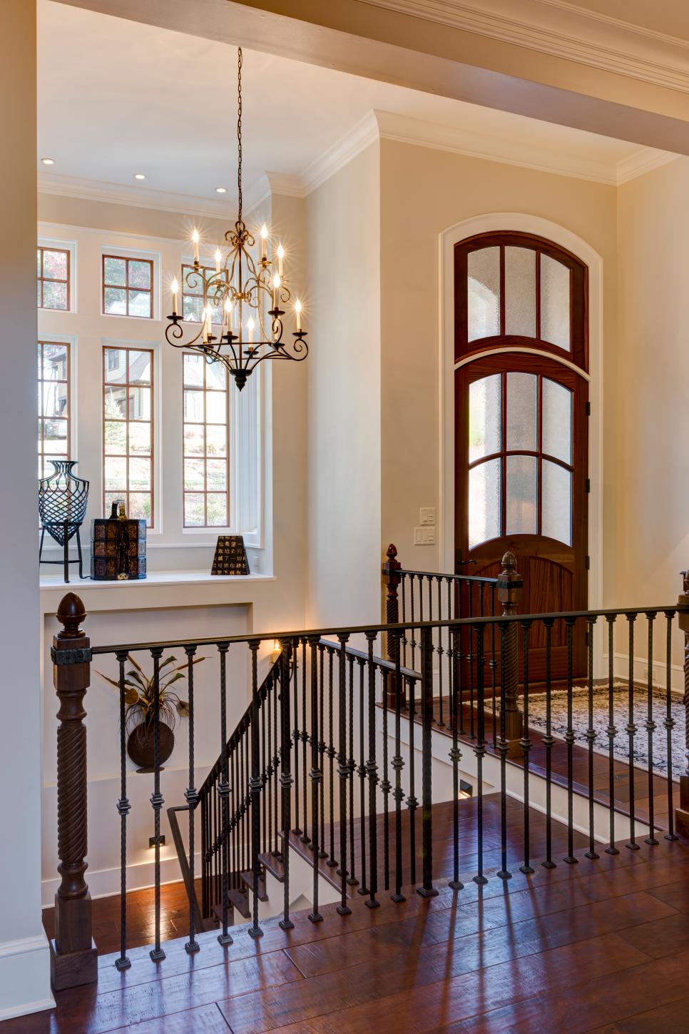 Foyer With Extravagant Chandelier Neutral Entrance With Staircase