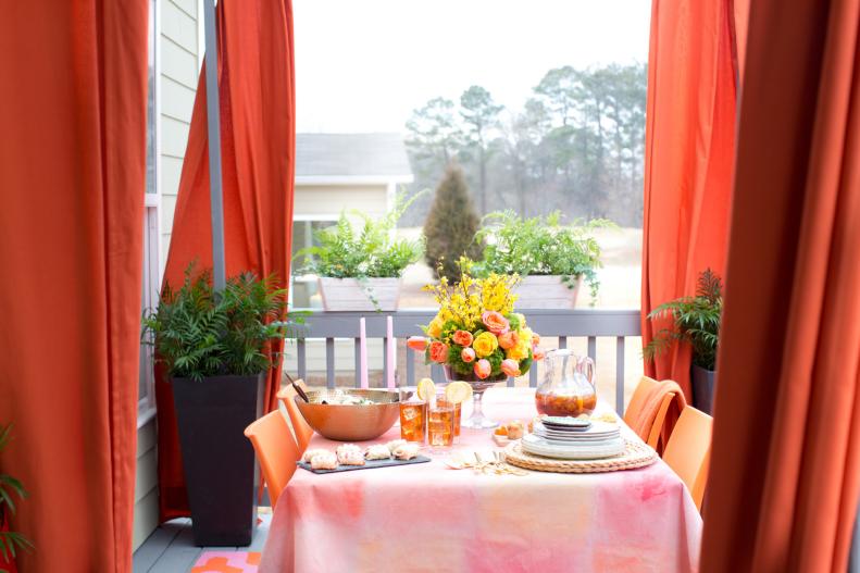For a fresh and gender-neutral take on spring, forget traditional pastels. At a brunch soiree hosted on the uncovered deck of the 2015 HGTV Spring House, a playful mix of tangerine, hot pink and soft textiles create a fresh and edgy backdrop.