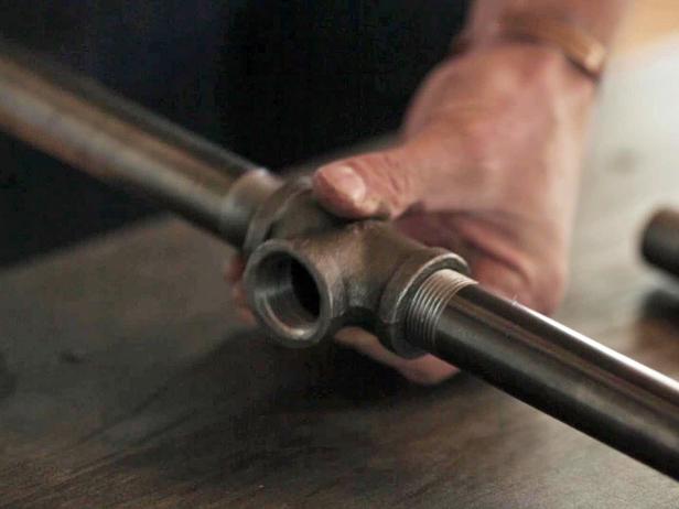 Make an industrial-style bench using only two materials - galvanized pipes and a wood board.