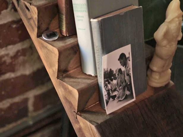 Make a ladder-style bookshelf using reclaimed wood, and attach it to the wall to save floor space.