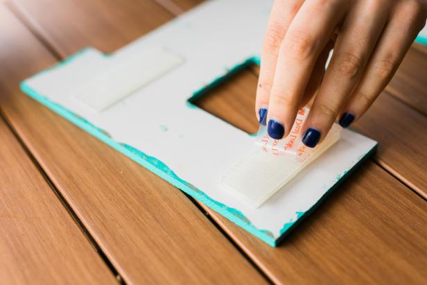 Attach the wall-gripping velcro to the letter-gripping velcro. Once it’s perfectly lined up and secure, remove the adhesive backing so that the letters can be secured to the wall.
