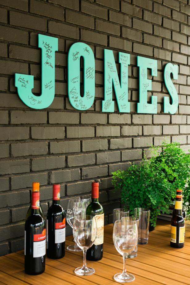Create one-of-a-kind signage for your new home with this interactive guest sign-in using basic chipboard letters and acrylic paint. You'll need the following materials for this project: chipboard alphabet letters, acrylic paint, 2-inch paint brush, foam paint brush, roll of contractor paper, velcro, 1 black permanent marker for each letter and a hair dryer.