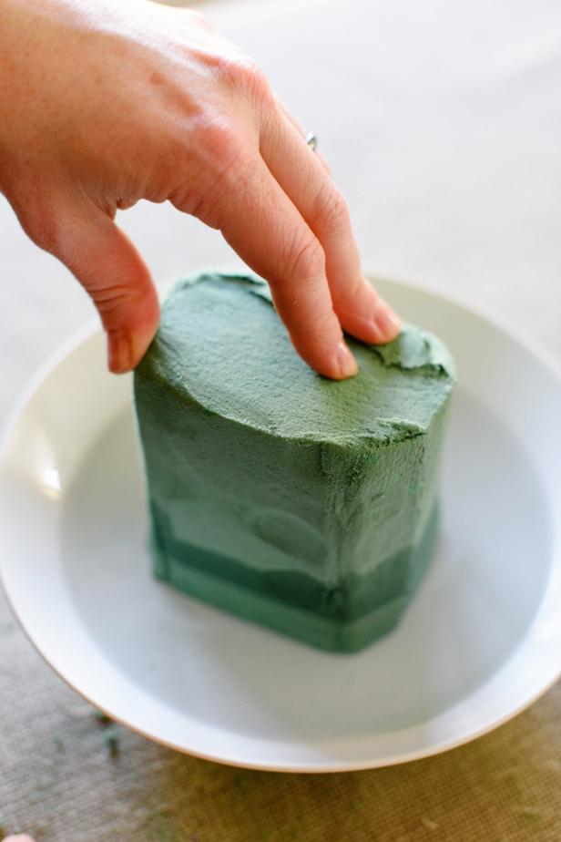 Place the floral foam in a small bowl filled with water. Allow the foam to soak up water until it is saturated.
