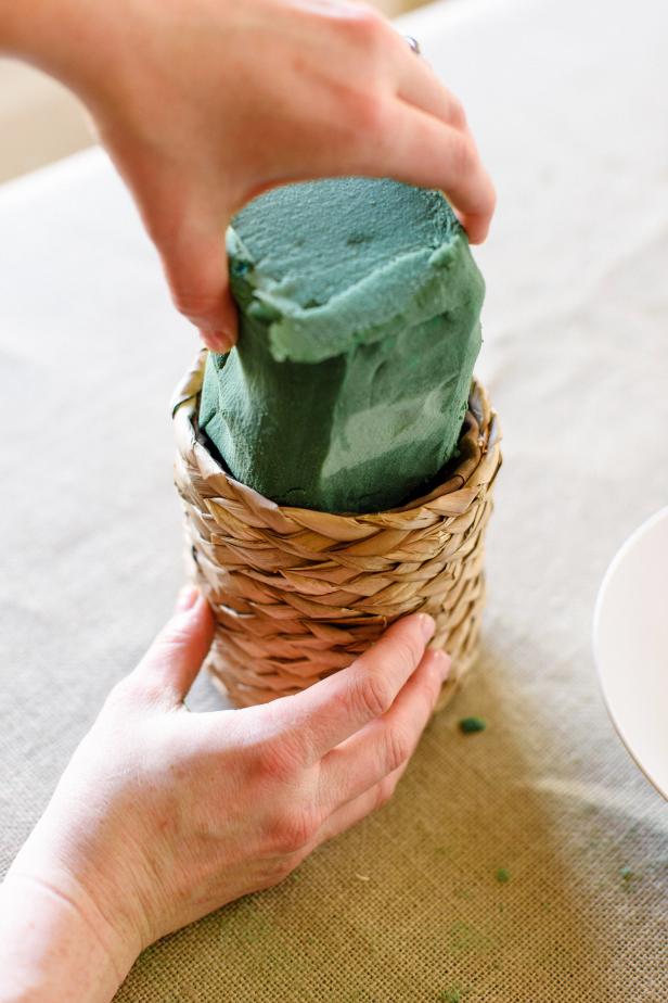 Gently insert the wet floral foam into the basket.