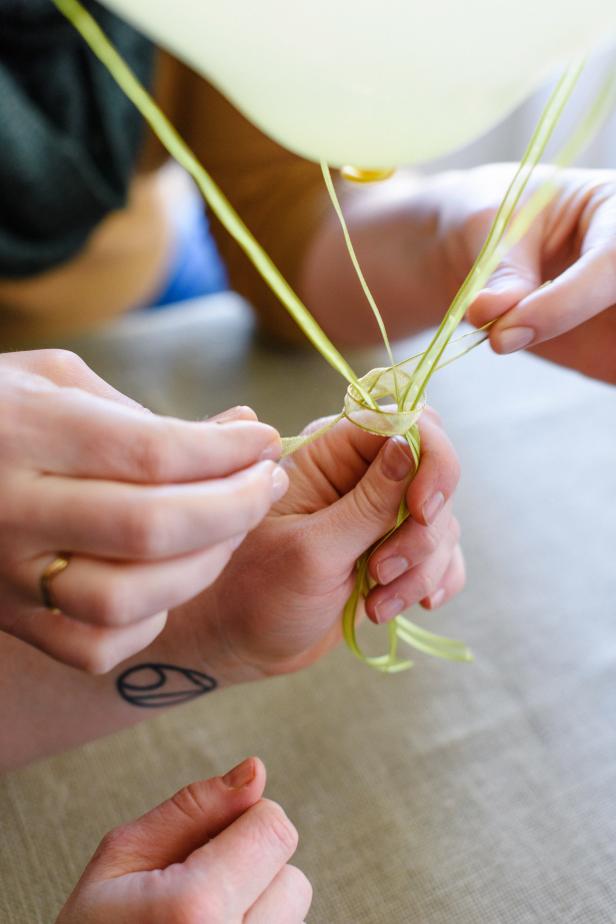 Cut a 6” piece of ribbon and tie around the four long, loose ribbon ends.