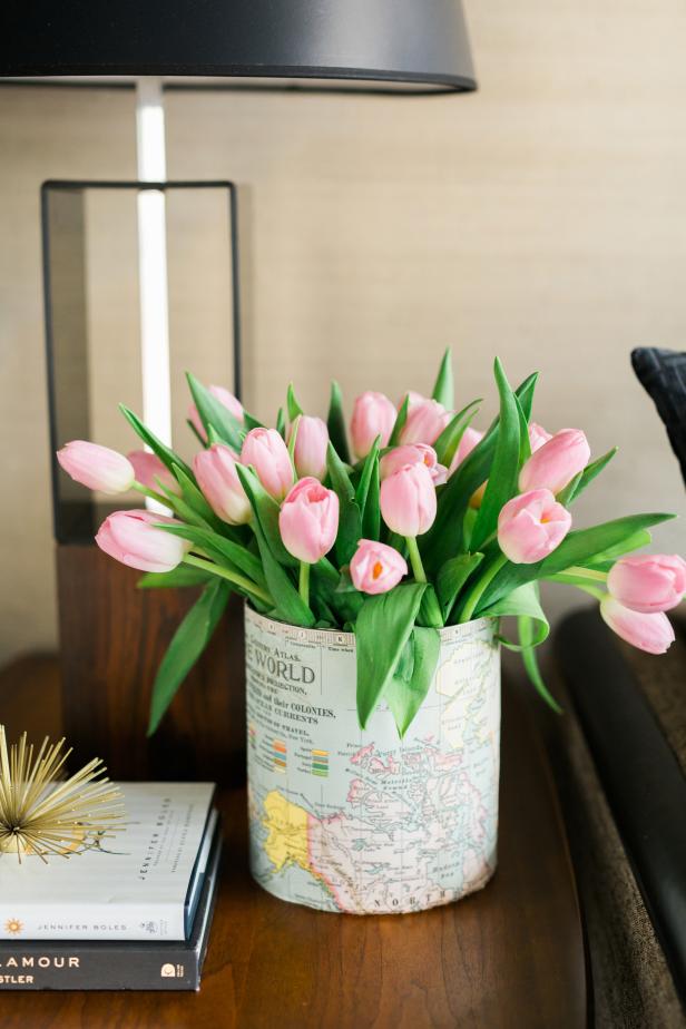 Colorful maps add a classic touch to glass vessels. You'll need the following materials for this project: an assortment of glass votive candle holders and vases, scissors, maps, a pencil, a ruler or straight edge and double-sided tape.