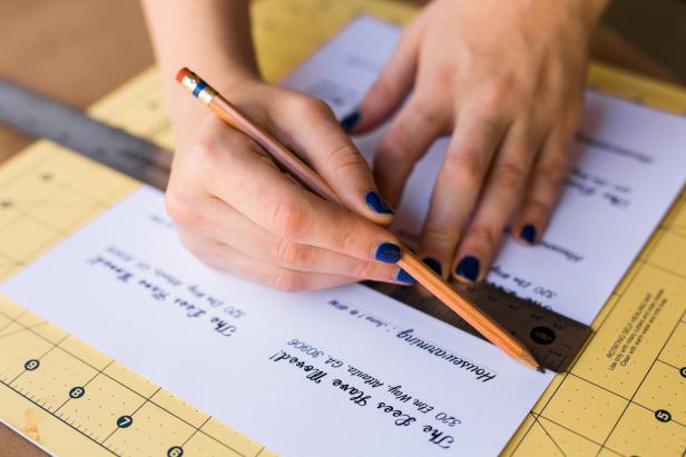Use the ruler and pencil to draw lines on the invitation and change of address announcement. These items need to be cut smaller so they will fit on the paint chips. Cut along the pencil lines with a craft knife or scissors to resize the announcements. TIP: You may want to measure the paint chips first to get an idea of how to resize the announcements.