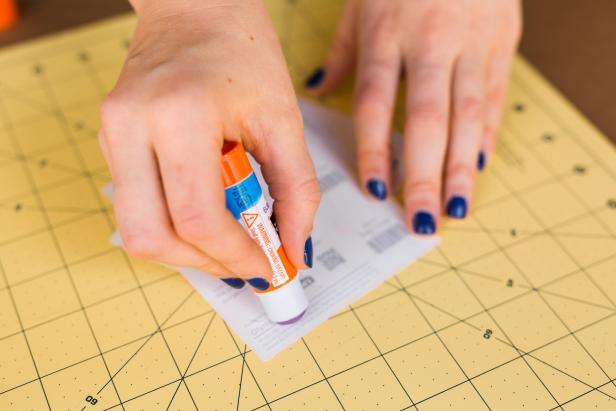 Run the glue stick along the perimeter of the slotted paint chip and attach another paint chip, color side up, to form the back of the card.