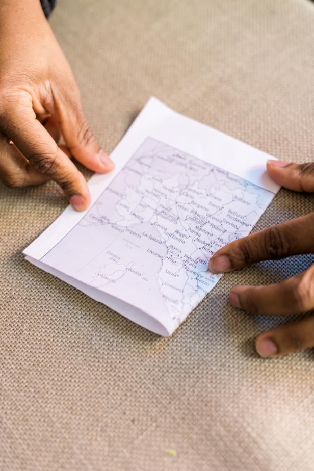 Fold one of the cut pages in half to create two pages.